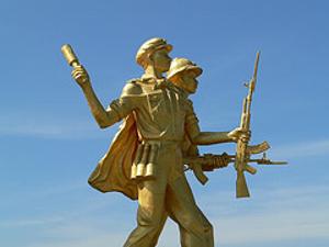 War memorial shows North Vietnamese and Pathet Lao soldiers attacking during the Vietnam War. 