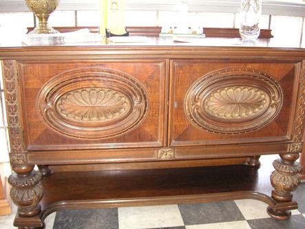 A circa 1920's walnut dining room table from H.E. Shaw Furniture Co. Manufacturers from Grand Rapids, Michigan.  It includes 8 chairs  2 with armrests and 6 without. They have walnut frames, backs covered in a velvet and floral bases.